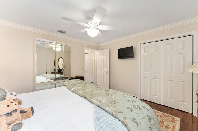 bedroom with visible vents, dark wood-style flooring, and ornamental molding