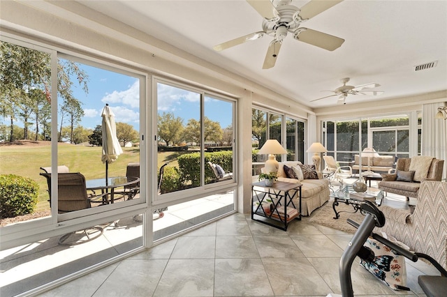 sunroom / solarium featuring an outdoor living space, tile patterned floors, ceiling fan, and visible vents