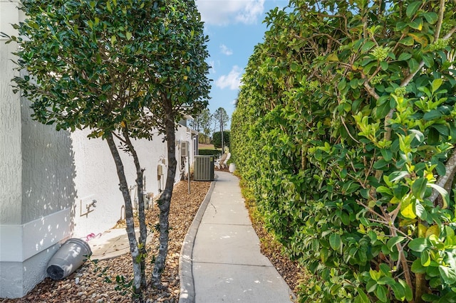 view of property exterior with stucco siding and fence