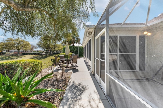 view of patio featuring a lanai and outdoor dining area