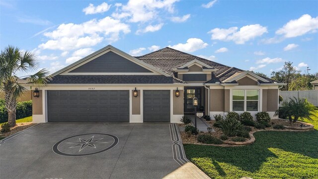 5557 Hawkins Dr, The Villages, FL 32163 - view of front of home featuring a front lawn, concrete driveway, stucco siding, and an attached garage