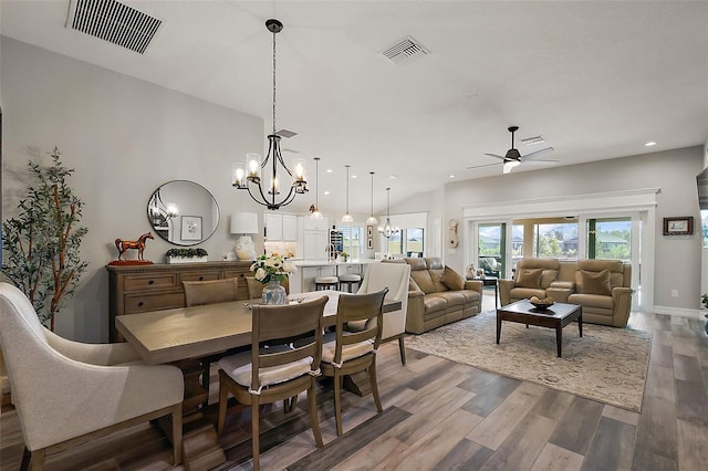 5557 Hawkins Dr, The Villages, FL 32163 - dining room featuring wood finished floors, recessed lighting, ceiling fan with notable chandelier, and visible vents