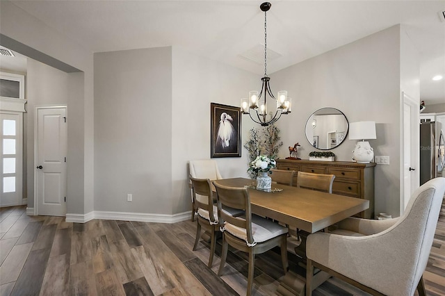 5557 Hawkins Dr, The Villages, FL 32163 - dining space with visible vents, a notable chandelier, baseboards, and wood finished floors