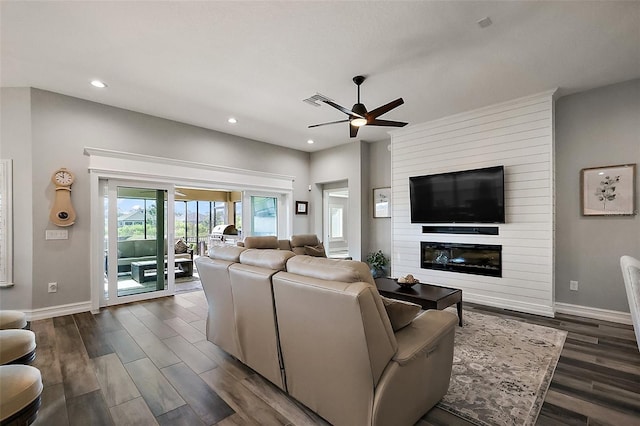 5557 Hawkins Dr, The Villages, FL 32163 - living room featuring a large fireplace, a ceiling fan, dark wood-style flooring, and recessed lighting