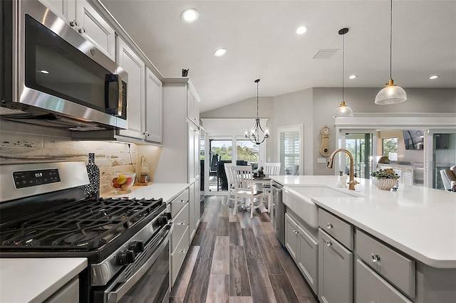 5557 Hawkins Dr, The Villages, FL 32163 - kitchen with gray cabinets, a sink, stainless steel appliances, and plenty of natural light