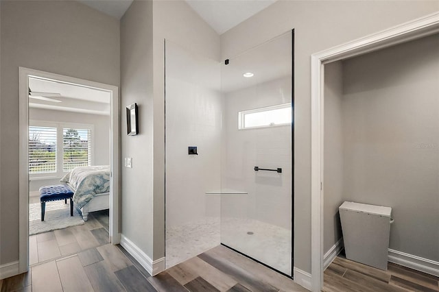 5557 Hawkins Dr, The Villages, FL 32163 - ensuite bathroom with ensuite bathroom, wood tiled floor, baseboards, and walk in shower