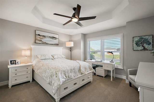 5557 Hawkins Dr, The Villages, FL 32163 - bedroom featuring baseboards, a tray ceiling, ceiling fan, and dark colored carpet