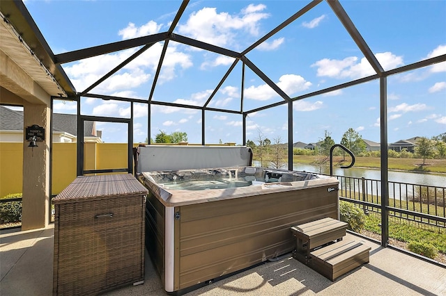 5557 Hawkins Dr, The Villages, FL 32163 - view of patio / terrace featuring glass enclosure, a water view, and a hot tub