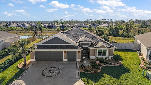5557 Hawkins Dr, The Villages, FL 32163 - view of front of home with fence, driveway, a garage, and a residential view