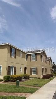 144 Primrose Dr, Davenport, FL 33837 - view of front facade featuring cooling unit and stucco siding