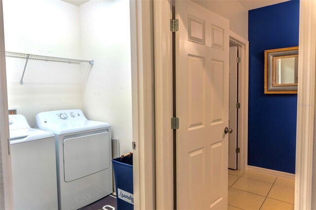 144 Primrose Dr, Davenport, FL 33837 - laundry room with independent washer and dryer, laundry area, baseboards, and light tile patterned floors