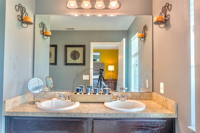 144 Primrose Dr, Davenport, FL 33837 - full bathroom featuring double vanity, visible vents, and a sink