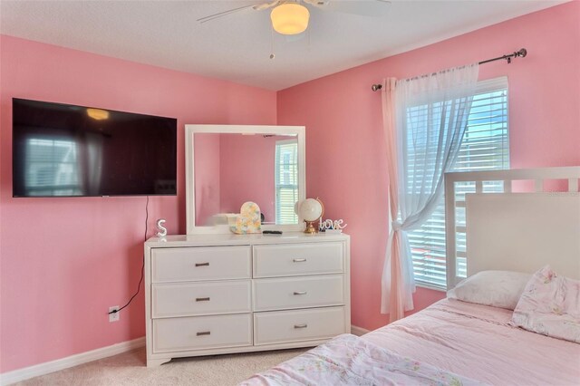 144 Primrose Dr, Davenport, FL 33837 - bedroom with a ceiling fan, light carpet, baseboards, and multiple windows
