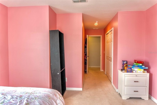 144 Primrose Dr, Davenport, FL 33837 - bedroom featuring baseboards, visible vents, a closet, and light carpet
