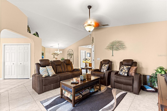living room with light tile patterned flooring, ceiling fan with notable chandelier, vaulted ceiling, and visible vents