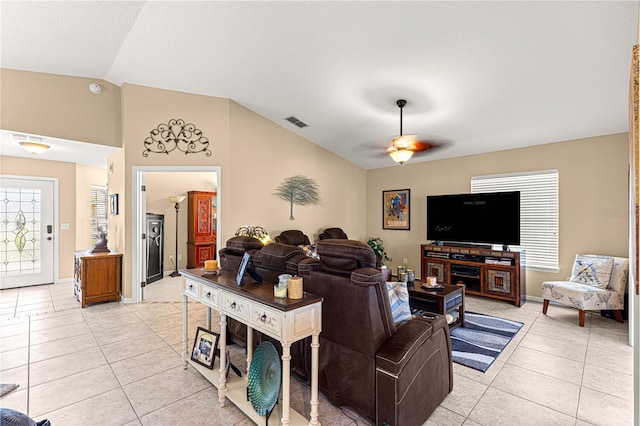 living area featuring light tile patterned floors, lofted ceiling, ceiling fan, and visible vents