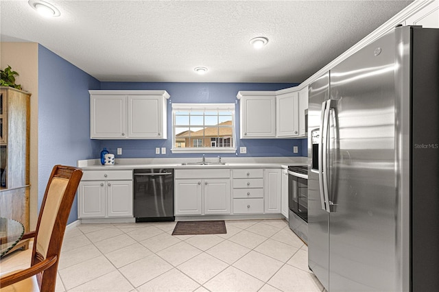 kitchen featuring light countertops, a sink, stainless steel appliances, and light tile patterned floors