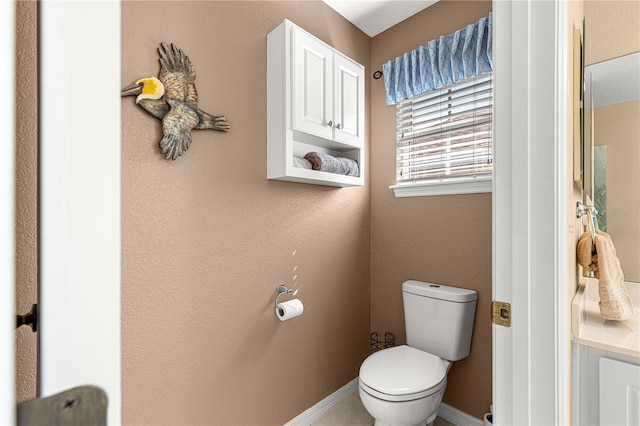 bathroom with baseboards and toilet