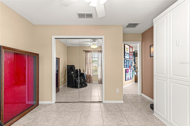 bedroom with light tile patterned flooring, baseboards, a closet, and visible vents