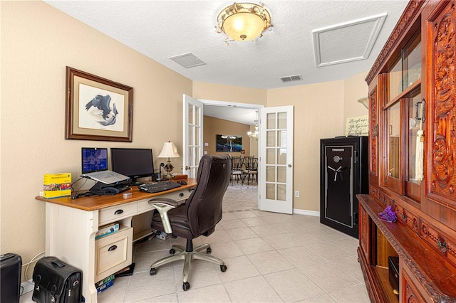 office space featuring light tile patterned flooring, visible vents, french doors, and a textured ceiling