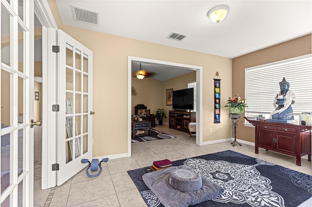 interior space featuring visible vents, french doors, and tile patterned flooring