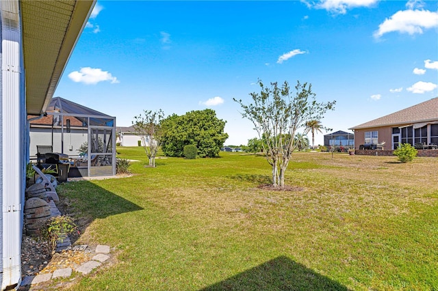 view of yard with glass enclosure