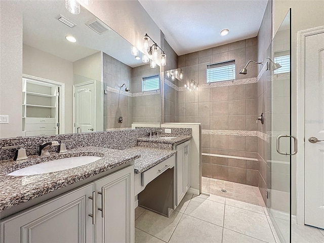 full bathroom featuring vanity, visible vents, a shower stall, and tile patterned flooring