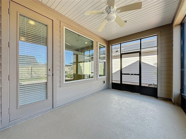 unfurnished sunroom featuring a ceiling fan