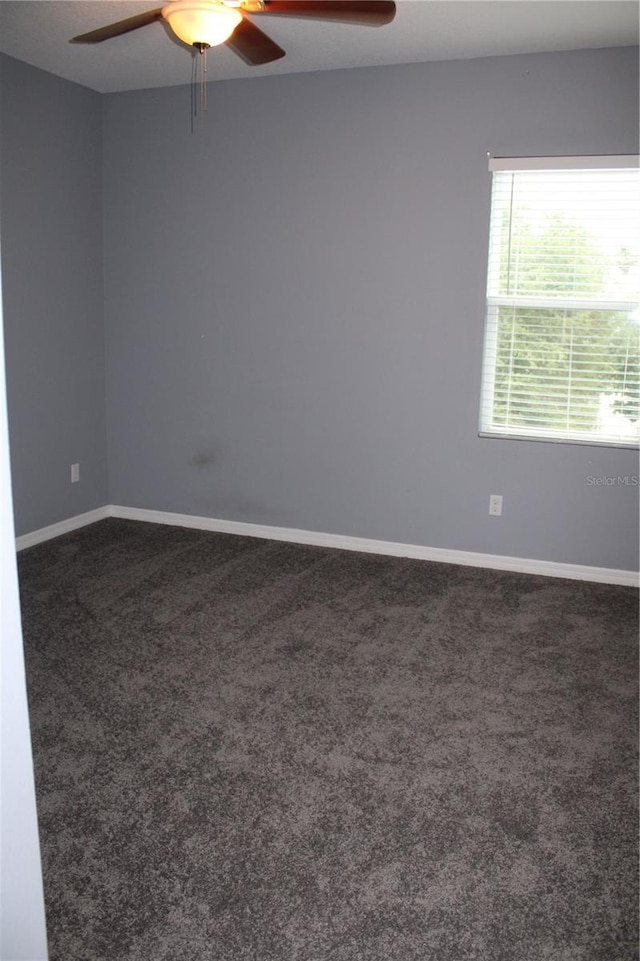 2572 Limerick Cir, Grand Island, FL 32735 - empty room featuring ceiling fan, dark colored carpet, and baseboards