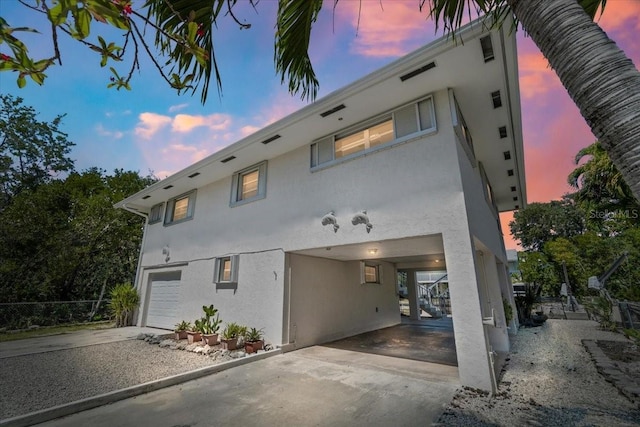 29051 Magnolia Ln, Big Pine Key, FL 33043 - view of front of property with a garage, driveway, and stucco siding