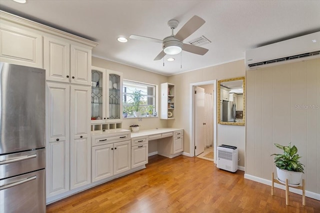 29051 Magnolia Ln, Big Pine Key, FL 33043 - kitchen featuring visible vents, a wall mounted air conditioner, ceiling fan, and freestanding refrigerator