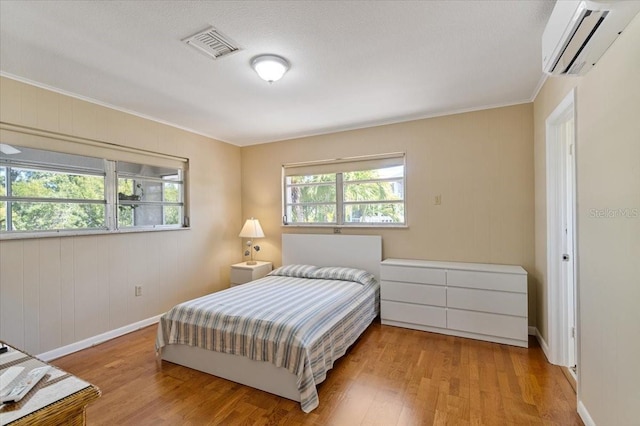 29051 Magnolia Ln, Big Pine Key, FL 33043 - bedroom with visible vents, an AC wall unit, crown molding, and wood finished floors