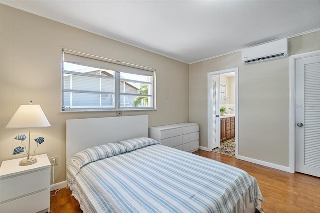 29051 Magnolia Ln, Big Pine Key, FL 33043 - bedroom with an AC wall unit, baseboards, and wood finished floors