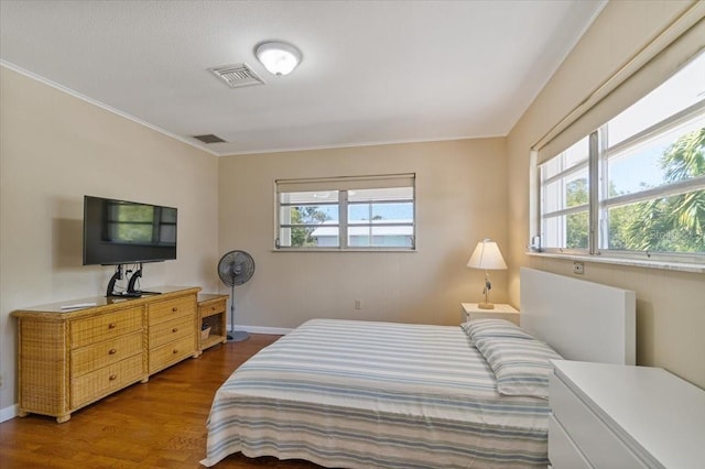 29051 Magnolia Ln, Big Pine Key, FL 33043 - bedroom featuring wood finished floors, ornamental molding, baseboards, and visible vents