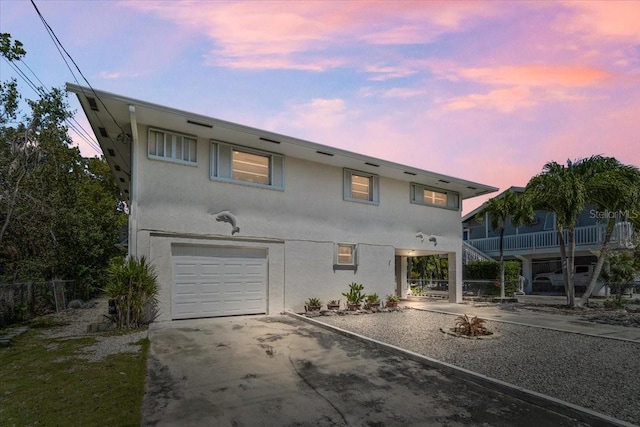 29051 Magnolia Ln, Big Pine Key, FL 33043 - view of front facade with concrete driveway, stucco siding, and an attached garage