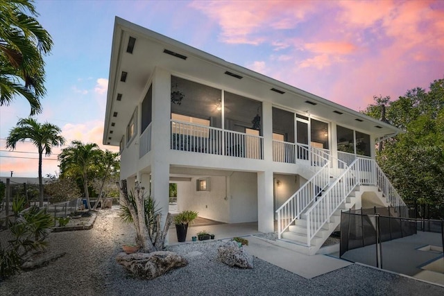 29051 Magnolia Ln, Big Pine Key, FL 33043 - property at dusk with stairs and fence