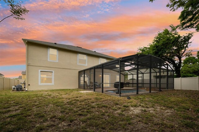 rear view of property with a fenced in pool, a patio area, stucco siding, a yard, and a fenced backyard