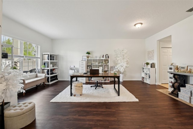 office with wood finished floors, visible vents, and baseboards