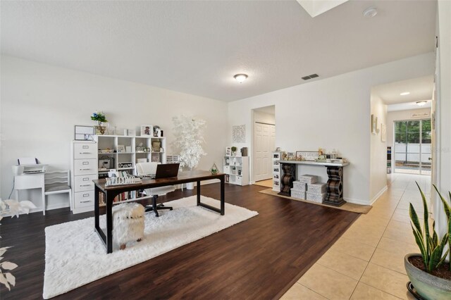 tiled office featuring baseboards and visible vents