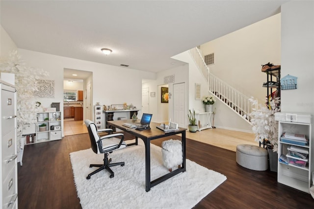 office space with visible vents and wood finished floors
