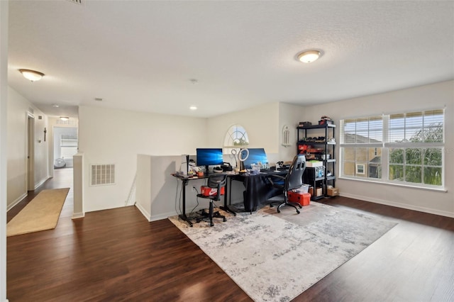 office featuring visible vents, wood finished floors, and baseboards