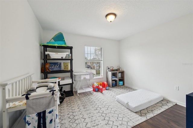 bedroom featuring wood finished floors and baseboards