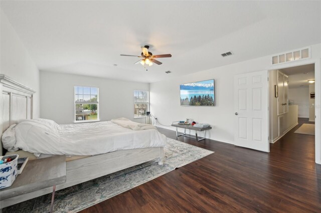 bedroom with visible vents, a ceiling fan, and dark wood finished floors