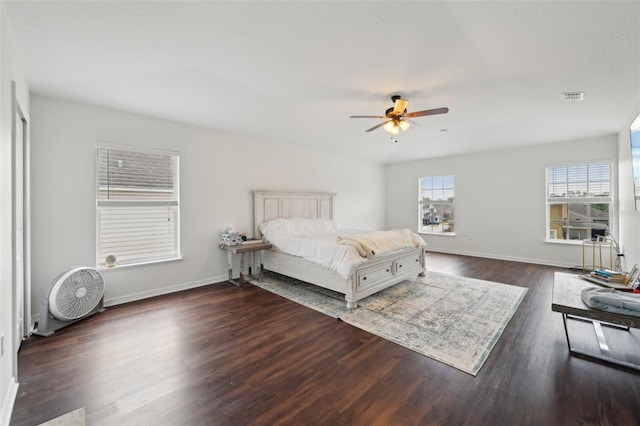 bedroom featuring visible vents, dark wood-style flooring, ceiling fan, and baseboards