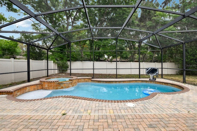 view of pool featuring a pool with connected hot tub, a fenced backyard, and a patio area