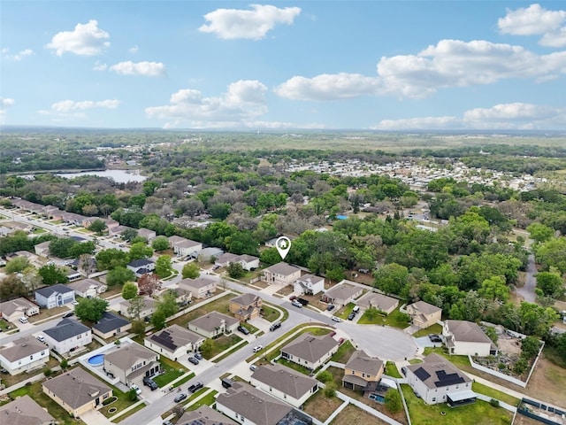birds eye view of property with a water view and a residential view