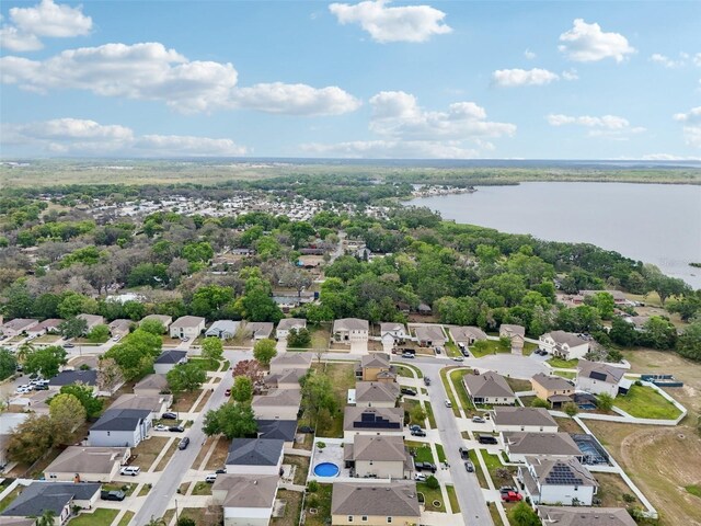 drone / aerial view with a residential view and a water view