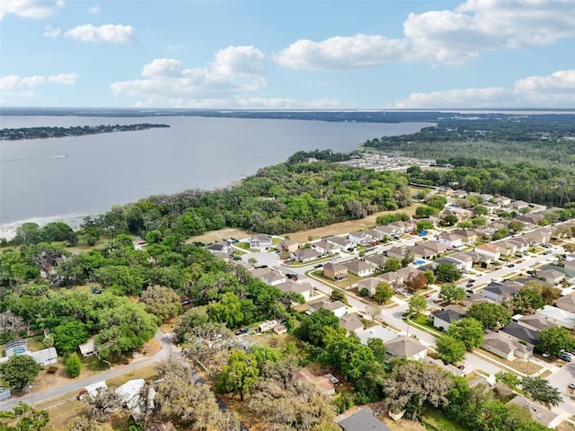 drone / aerial view with a water view and a residential view