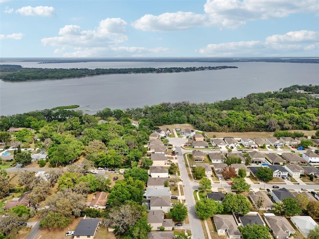 drone / aerial view featuring a water view and a residential view