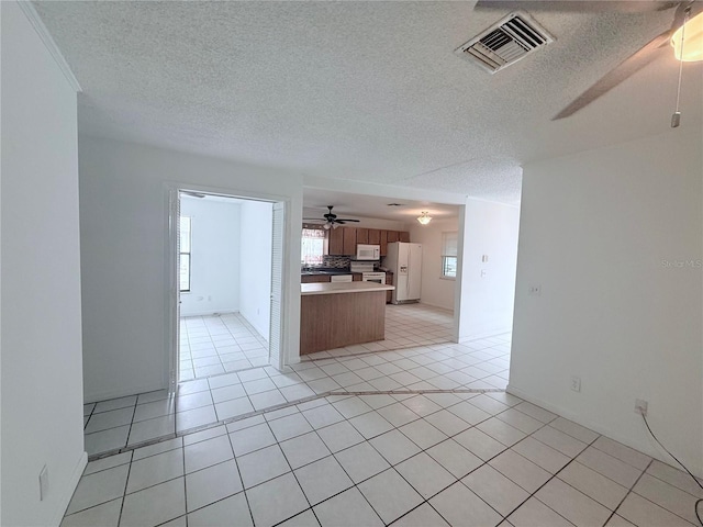 2423 Centennial Blvd, Leesburg, FL 34748 - kitchen with visible vents, white appliances, ceiling fan, open floor plan, and light tile patterned floors